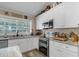 Updated kitchen with stainless steel appliances, granite countertops, and bright natural light at 11806 Sw 61St Place Rd, Ocala, FL 34481