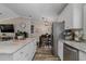 Modern kitchen featuring white cabinetry, stainless steel appliances and a kitchen island at 11806 Sw 61St Place Rd, Ocala, FL 34481