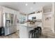 Bright kitchen features stainless steel appliances, white cabinetry, and an island with seating at 11806 Sw 61St Place Rd, Ocala, FL 34481