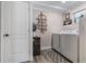 This laundry space features stacked washer-dryer units, decor, and convenient access to the rest of the home at 11806 Sw 61St Place Rd, Ocala, FL 34481