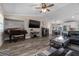 Living room showcasing neutral paint, plank flooring, an entertainment center, and a piano at 11806 Sw 61St Place Rd, Ocala, FL 34481
