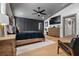 Spacious main bedroom featuring wood floors, a large dresser with a TV, and a dark accent wall at 11806 Sw 61St Place Rd, Ocala, FL 34481
