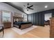 Spacious main bedroom featuring a tray ceiling, natural light, and dark accent wall at 11806 Sw 61St Place Rd, Ocala, FL 34481