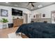 Spacious main bedroom with wood floors and a large dresser with a TV at 11806 Sw 61St Place Rd, Ocala, FL 34481