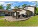 Backyard patio with outdoor dining and relaxation furniture, perfect for entertaining at 11806 Sw 61St Place Rd, Ocala, FL 34481