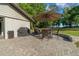 Paver patio with a grill, outdoor dining table, and an egg chair for relaxation at 11806 Sw 61St Place Rd, Ocala, FL 34481
