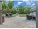 Paver patio features an outdoor seating area, umbrella, and views of the lush landscaping at 11806 Sw 61St Place Rd, Ocala, FL 34481