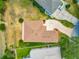 Aerial view of home with a patterned driveway and lush landscaping at 11945 Se 171St Loop, Summerfield, FL 34491