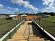 Baseball field access with metal stairs and railing, showcasing a well-maintained diamond and spectator seating at 11945 Se 171St Loop, Summerfield, FL 34491