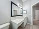 Bathroom vanity with white cabinets and marble countertop at 11945 Se 171St Loop, Summerfield, FL 34491