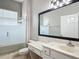 This bathroom includes a vanity with lots of storage space and a shower with glass doors at 11945 Se 171St Loop, Summerfield, FL 34491