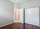 Bedroom featuring wood floor and closet with sliding doors at 11945 Se 171St Loop, Summerfield, FL 34491
