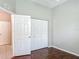 Cozy bedroom featuring hardwood floors, a spacious closet, and natural light at 11945 Se 171St Loop, Summerfield, FL 34491