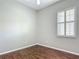 Bright bedroom featuring wood floors and window with shutters at 11945 Se 171St Loop, Summerfield, FL 34491