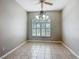 Spacious dining room with tile floors, a modern chandelier, and a large window offering plenty of natural light at 11945 Se 171St Loop, Summerfield, FL 34491