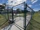 Fenced dog park with concrete base, play equipment and benches, providing a secure space for pets to exercise at 11945 Se 171St Loop, Summerfield, FL 34491
