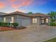 Charming home featuring a circle driveway with a decorative star inlay and well manicured landscaping at 11945 Se 171St Loop, Summerfield, FL 34491