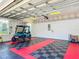 Garage featuring finished ceiling, race deck floors, and a golf cart at 11945 Se 171St Loop, Summerfield, FL 34491