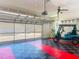 The garage is spacious with a colorfully tiled floor and a golf cart at 11945 Se 171St Loop, Summerfield, FL 34491