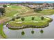 Scenic golf course with a water hazard, lush green grass, sand traps, and views of surrounding homes at 11945 Se 171St Loop, Summerfield, FL 34491