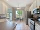 Bright kitchen with white cabinets, stainless appliances, an eat-in kitchen and sliding doors to screened in lanai at 11945 Se 171St Loop, Summerfield, FL 34491