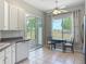 Cozy breakfast nook with white cabinets, stainless steel appliances, and views of the lush greenery outside at 11945 Se 171St Loop, Summerfield, FL 34491