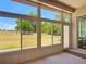 Inviting enclosed lanai featuring expansive windows offering peaceful views of the lush greenery at 11945 Se 171St Loop, Summerfield, FL 34491