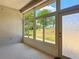 Cozy enclosed lanai featuring wall-to-wall windows and carpet flooring offering panoramic views of the yard at 11945 Se 171St Loop, Summerfield, FL 34491