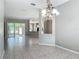 Open living space with tile flooring, leading to the kitchen and a screened-in patio, perfect for entertaining at 11945 Se 171St Loop, Summerfield, FL 34491