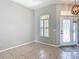 Open living area featuring tile floors, a decorative light fixture, a window and an entryway at 11945 Se 171St Loop, Summerfield, FL 34491