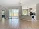 Open living area featuring tile floors, a ceiling fan, archways and a kitchen with white cabinets at 11945 Se 171St Loop, Summerfield, FL 34491