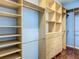 Large walk-in closet featuring custom wood shelving and storage, including cabinets at 11945 Se 171St Loop, Summerfield, FL 34491