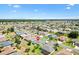 An aerial view of the home and the surrounding community featuring mature trees and lush landscaping at 12147 Se 173Rd Pl, Summerfield, FL 34491