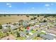 A beautiful aerial view of the home with green lawn, mature landscaping, and the surrounding community at 12147 Se 173Rd Pl, Summerfield, FL 34491