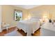 Cozy bedroom with hardwood floors, natural light, and neutral tones at 12147 Se 173Rd Pl, Summerfield, FL 34491
