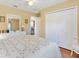 Well-lit bedroom features a ceiling fan, wood floors, and large closet at 12147 Se 173Rd Pl, Summerfield, FL 34491