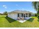 Well-manicured backyard includes patio seating and enclosed lanai at 12147 Se 173Rd Pl, Summerfield, FL 34491
