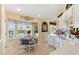 Charming eat-in kitchen features white cabinets, sleek countertops, and a bright breakfast nook at 12147 Se 173Rd Pl, Summerfield, FL 34491