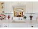 Bright kitchen sink with white cabinetry and granite countertops, open to the living room at 12147 Se 173Rd Pl, Summerfield, FL 34491