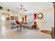 Inviting living room with comfortable seating, tile floors, and warm natural light at 12147 Se 173Rd Pl, Summerfield, FL 34491