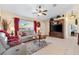 Cozy living room with a comfortable seating area and a ceiling fan for added comfort at 12147 Se 173Rd Pl, Summerfield, FL 34491