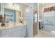 Bright bathroom with glass shower doors and a white vanity at 12147 Se 173Rd Pl, Summerfield, FL 34491