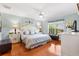 Bright main bedroom featuring hardwood floors, a ceiling fan, and elegant decor at 12147 Se 173Rd Pl, Summerfield, FL 34491