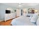 Bright main bedroom featuring hardwood floors and a white dresser at 12147 Se 173Rd Pl, Summerfield, FL 34491