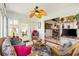 Cozy sun room with wicker furniture and lots of natural light, leading to dining area at 12147 Se 173Rd Pl, Summerfield, FL 34491