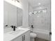 Modern bathroom features a quartz countertop, black fixtures, and white marbled tile in shower area at 12689 Sw 81St St, Dunnellon, FL 34432