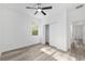 A sunny room showcases gray flooring, a ceiling fan, a large closet, and bright natural light at 12689 Sw 81St St, Dunnellon, FL 34432