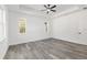 Comfortable bedroom featuring neutral walls, stylish floors, a window and a modern ceiling fan at 12689 Sw 81St St, Dunnellon, FL 34432