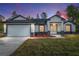 Well-lit single Gathering home featuring a front-facing two-car garage and welcoming front entrance at 12689 Sw 81St St, Dunnellon, FL 34432