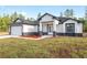 Newly built one story home with front facing 2 car garage, stylish accents, and small flower bed at 12689 Sw 81St St, Dunnellon, FL 34432